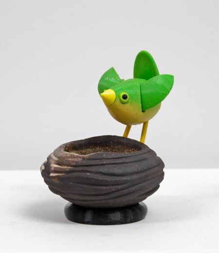 stoneware bird nest II, with green bird by Chris Barnes