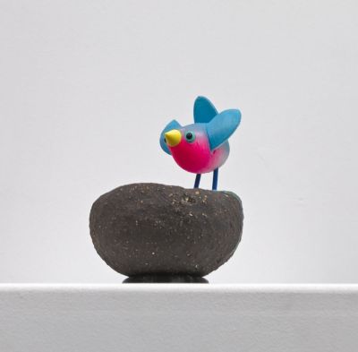 blue bird on black nest with open wings by Chris Barnes