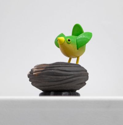 stoneware bird nest II, with green bird by Chris Barnes