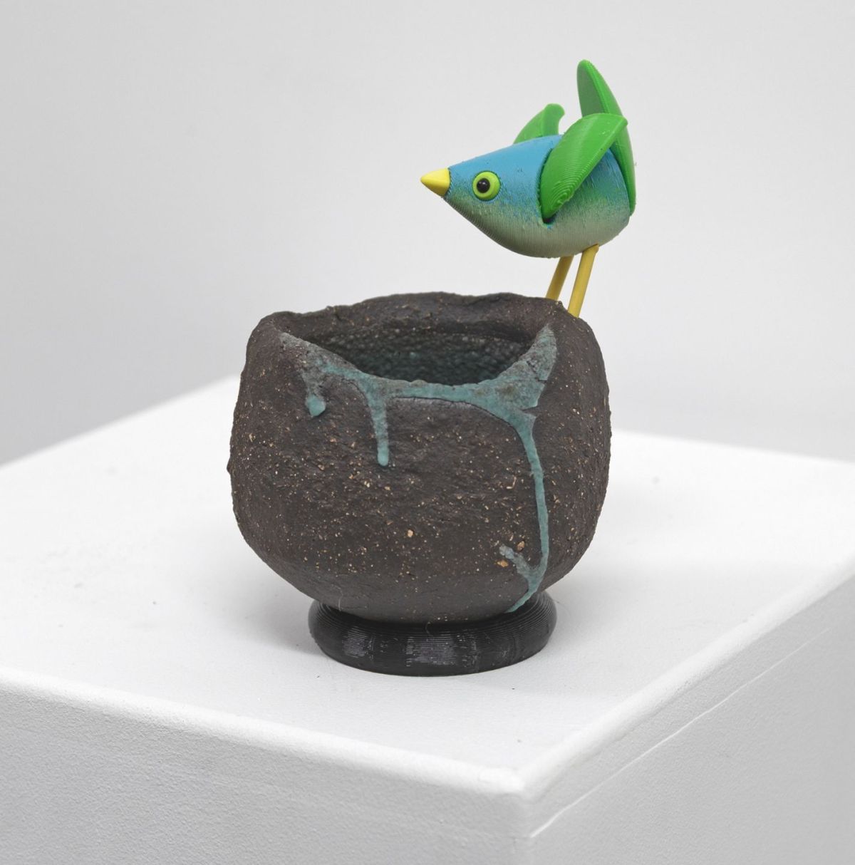 stoneware bird nest I, with green bird by Chris Barnes